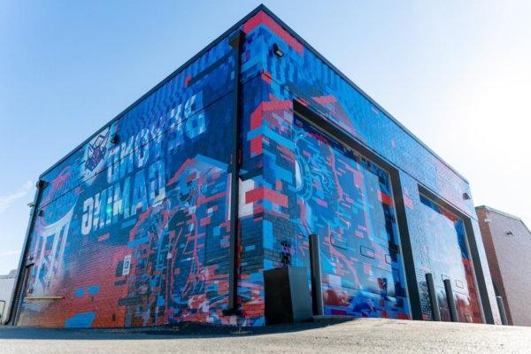 Exterior photo of the Shenandoah University Esports Arena. Shows imaging that says "Beyond Gaming."